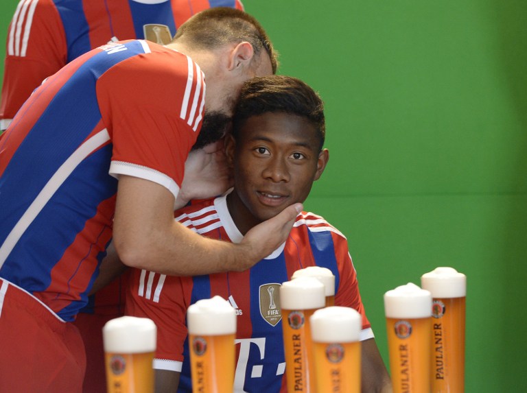 (L-R) Bayern Munich's French midfielder Franck Ribery and Bayern Munich's Austrian defender David Alaba speak at the set of a beer advertising photo shoot of German first division Bundesliga football club FC Bayern Munich in Munich, southern Germany, on August 31, 2014. AFP PHOTO/CHRISTOF STACHE